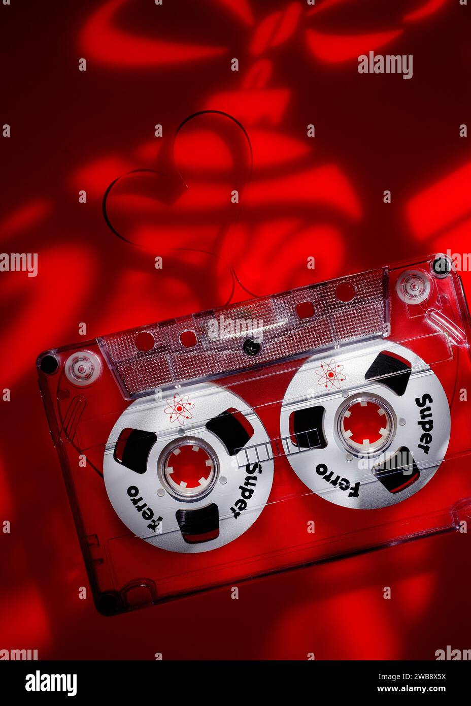 Klaipeda, Litauen - 27. Dezember 2023: Lichtprojektionen über ein festliches Weihnachtsthema auf rotem Acryl mit Audiokassette. Vertikales Foto. Stockfoto