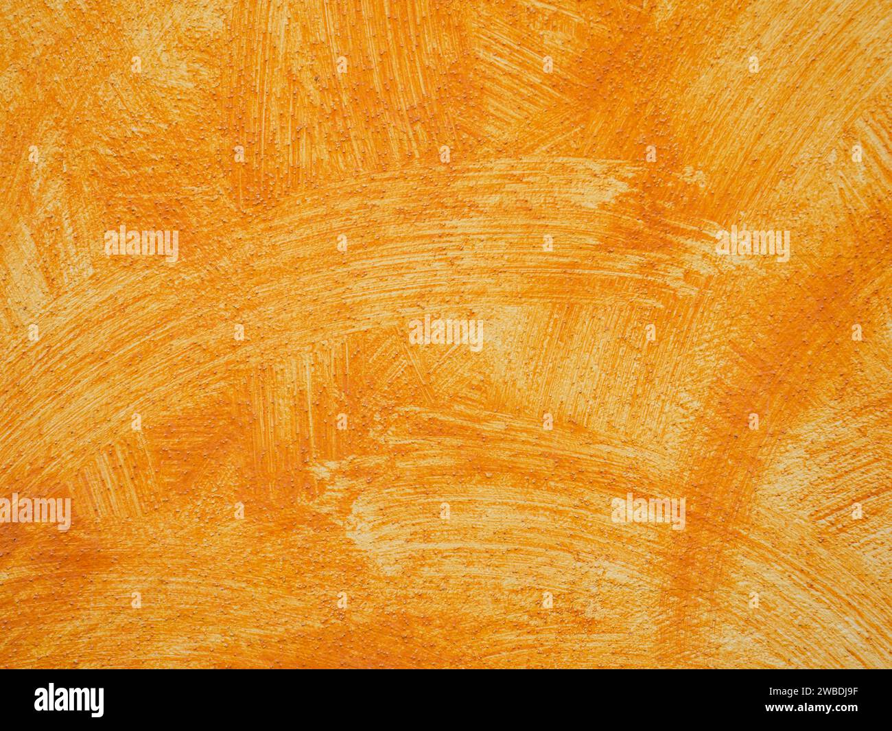 Orangefarbene Wand mit Gipsmuster Stockfoto