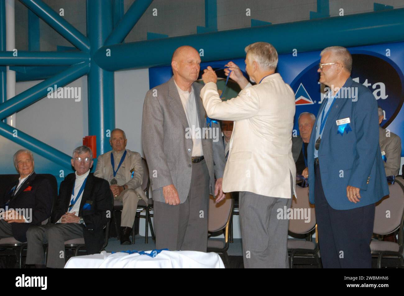 Im Apollo-Saturn V Visitor Complex des Kennedy Space Centers vergibt der Vorsitzende Owen Garriott eine Medaille an den neuen Astronaut Hall of Fame, Gordon Fullerton. Die Hall of Famers, darunter Fred Haise, waren anwesend. Die Zeremonie ehrt 60 Astronauten für ihre Flugleistungen und Beiträge zum US-Raumfahrtprogramm, einschließlich Space Shuttle-Missionen. Stockfoto