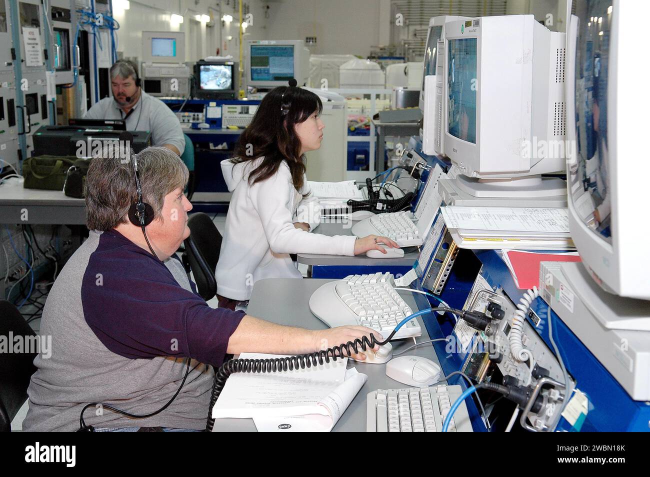 RAUMFAHRTZENTRUM KENNEDY, FLA. - Nancy Lowry (links) und Mikiko Ujihara überwachen zusammen mit Boeing das Payload Test and Checkout System für das Human Research Facility (HRF) Rack -2 Payload. Die HRF-2 wird auf der Rückfahrt zum Raumschiff STS-114 fliegen. Die HRF-2 wird der Internationalen Raumstation zusätzliche biomedizinische Instrumente und Forschungskapazitäten zur Verfügung stellen. HRF Rack 1 enthält ein Ultraschallgerät und ein Gasanalysatorsystem und ist seit Mai 2001 im US-Labor in Betrieb. HRF-2 wird auch im US-Labor installiert und liefert strukturelle, thermische, thermische und technische Daten Stockfoto