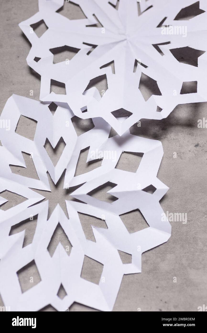 Nahaufnahme von Schneeflockenausschnitten aus weißem Papier Stockfoto