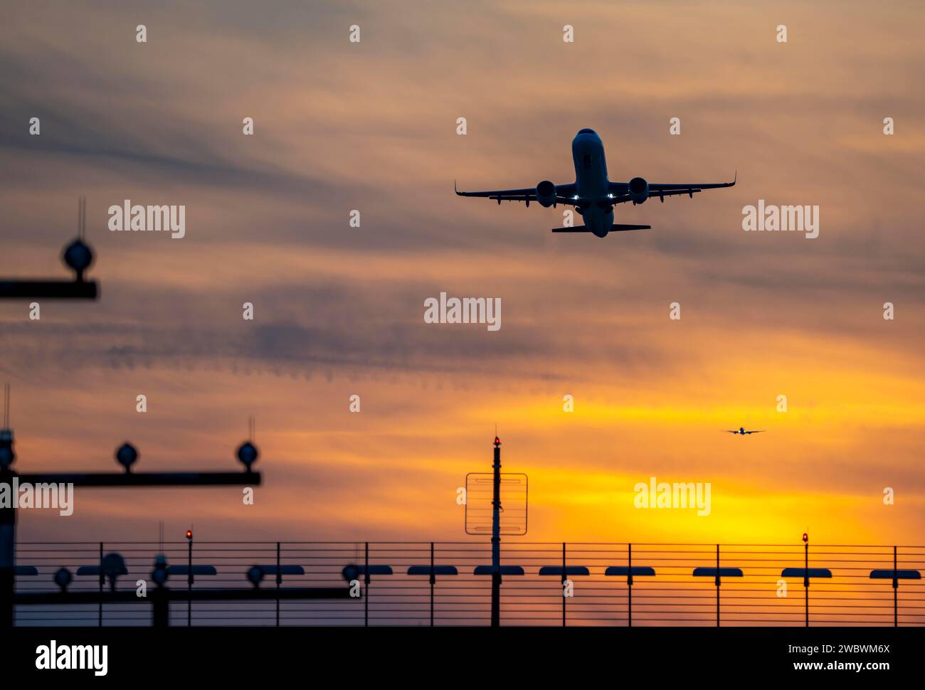 Start- und Landebahnbeleuchtung, Anflughilfen, am Flughafen Düsseldorf, Sonnenuntergang, Flugzeuge, die auf die südliche Hauptbahn starten und sich nähern, 05R/23L, NR Stockfoto