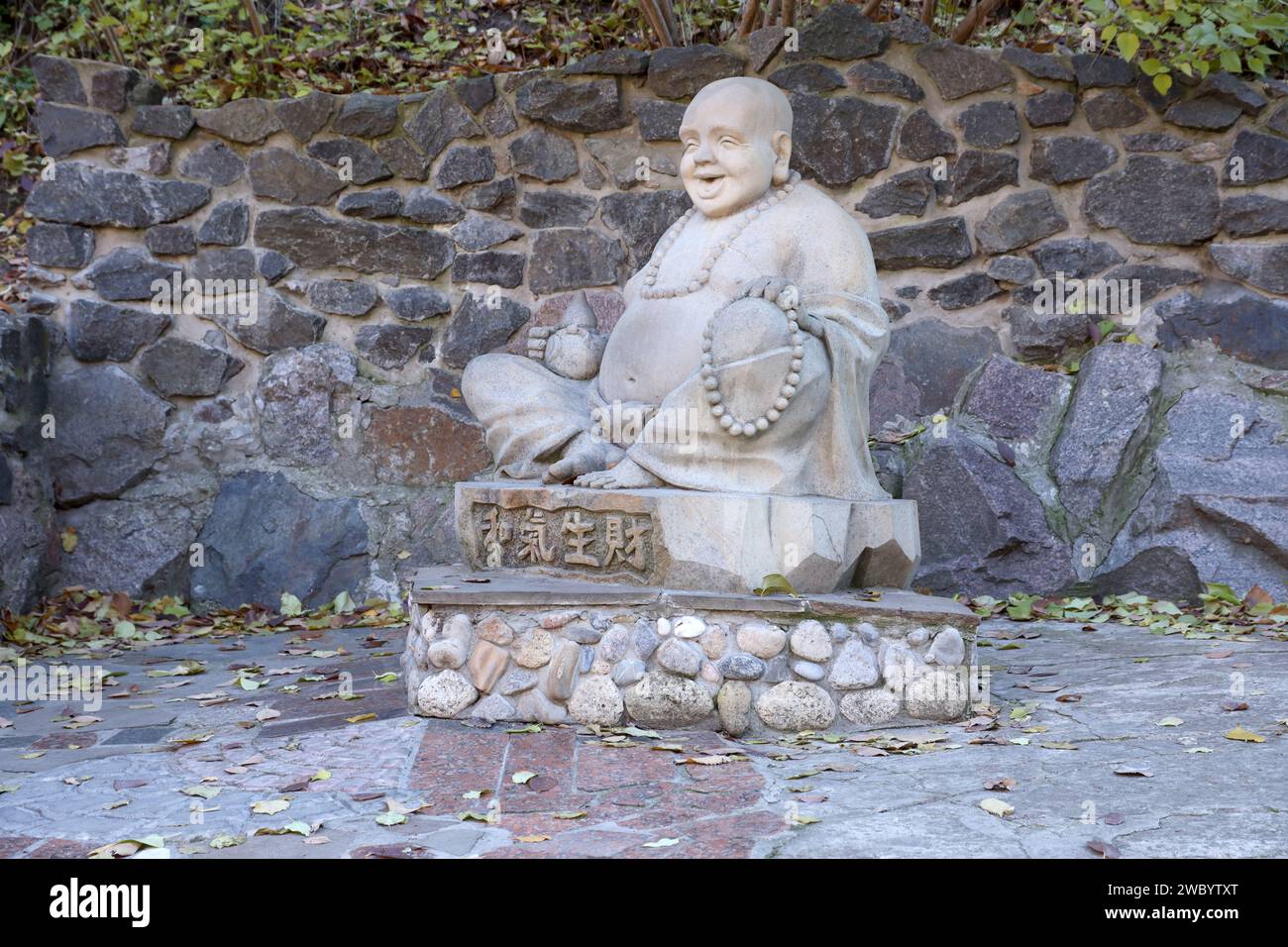 Cherkasy, UKRAINE - 20. OKTOBER 2021 Joyful Buddah Betonstatue in Grau nahe dem Weißen Lotus buddhistischen Tempel in Tscherkasy, Ukraine Stockfoto
