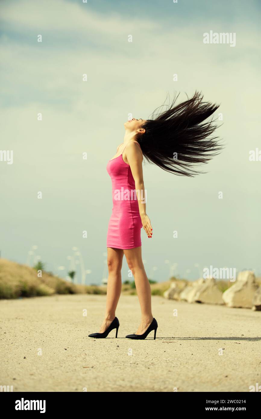 Frau in High Heels, die die Haare hochwirft Stockfoto