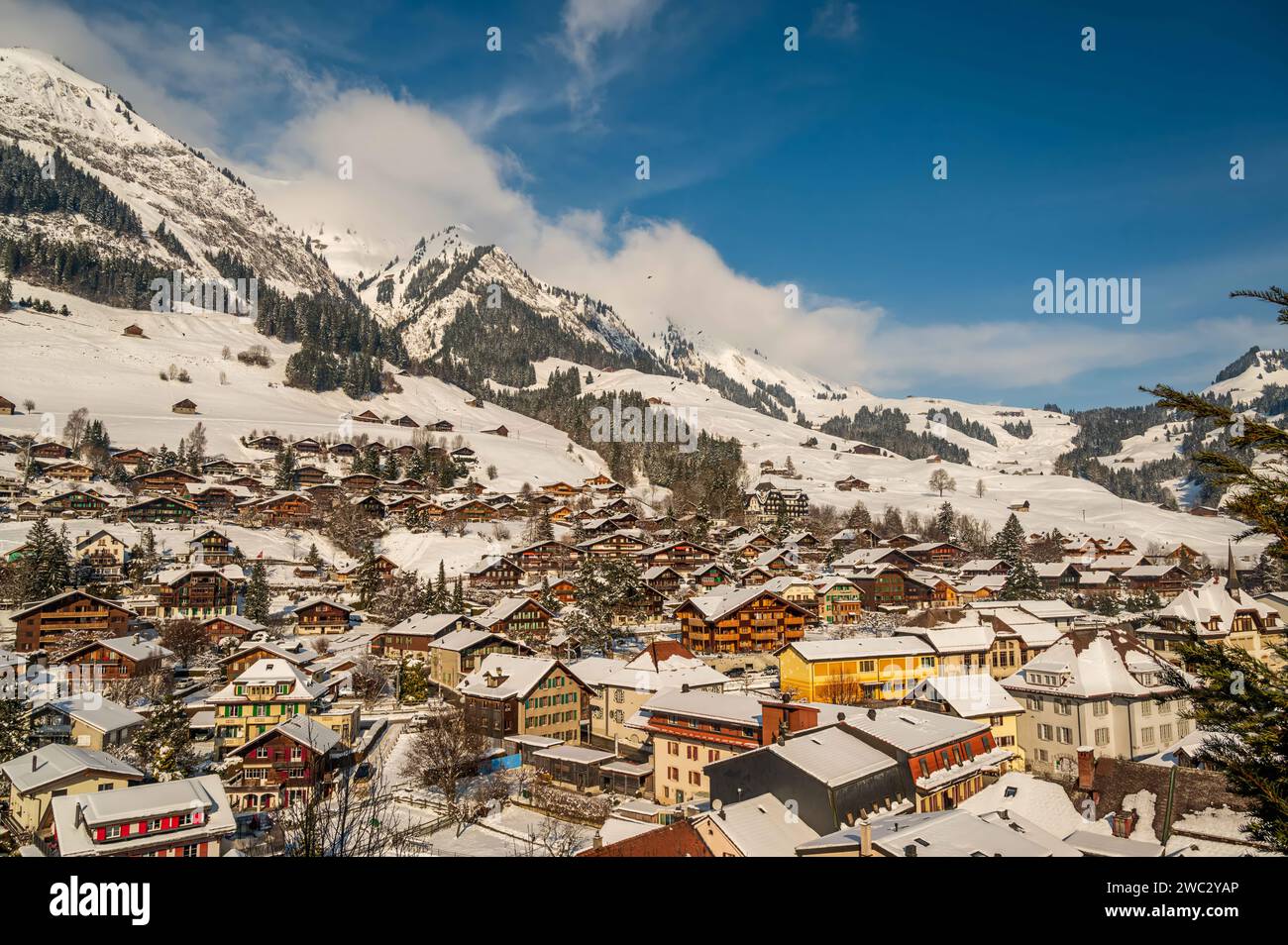 Winterlandschaft des Dorfes CHATEAU D'OEX. Kanton Waadt, Schweiz. Berg, Himmel und Schweizer Chalet. Stockfoto