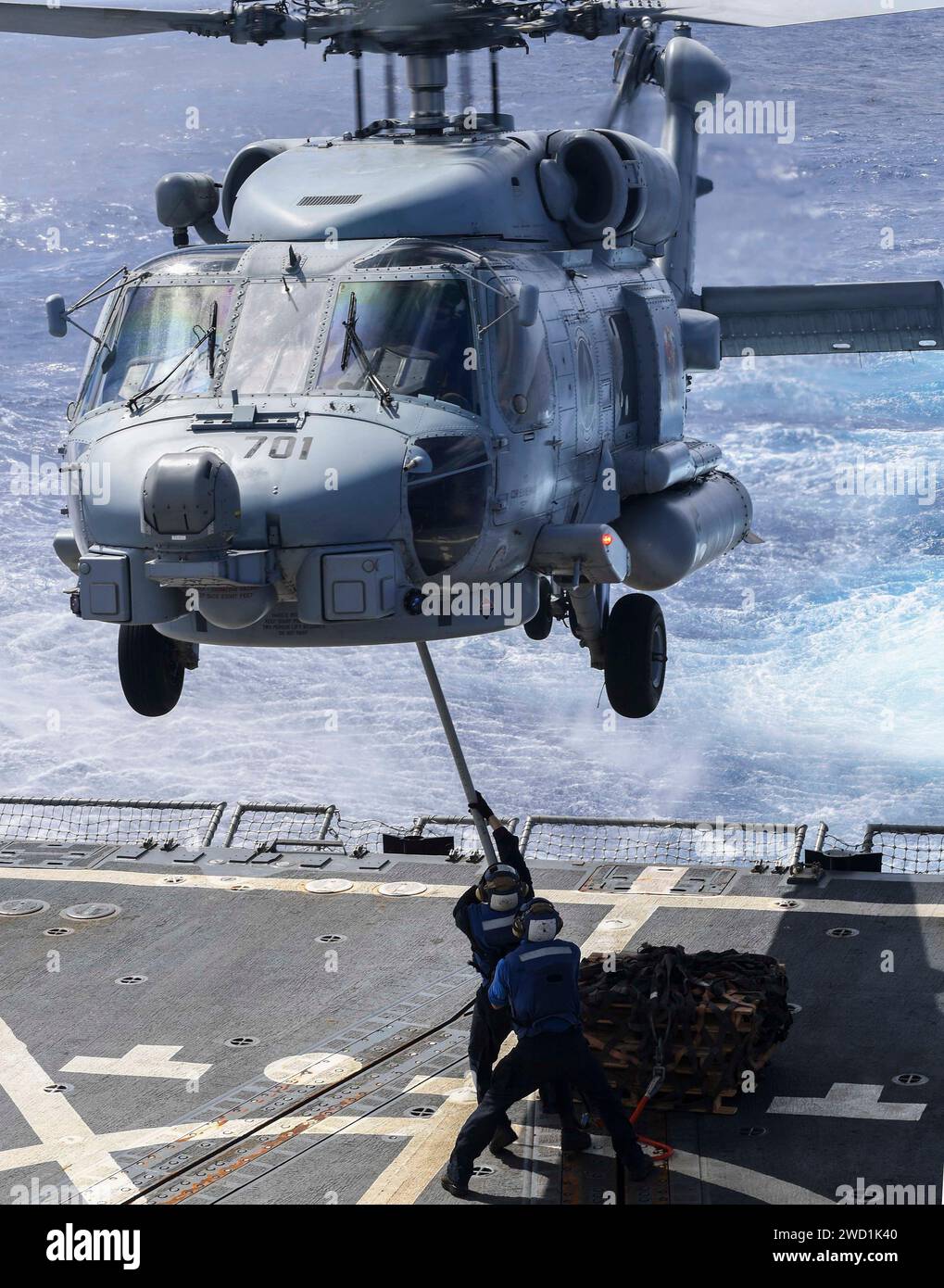 Seeleute üben das Anbringen von Paletten an einem MH-60R Sea Hawk Hubschrauber an Bord der USS Wayne E. Meyer. Stockfoto