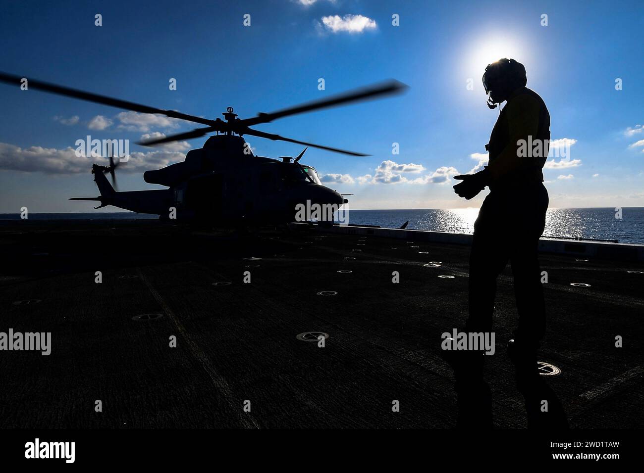 Aviation Support Equipment Technician steuert einen UH-1Y Hubschrauber auf dem Flugdeck der USS San Diego. Stockfoto