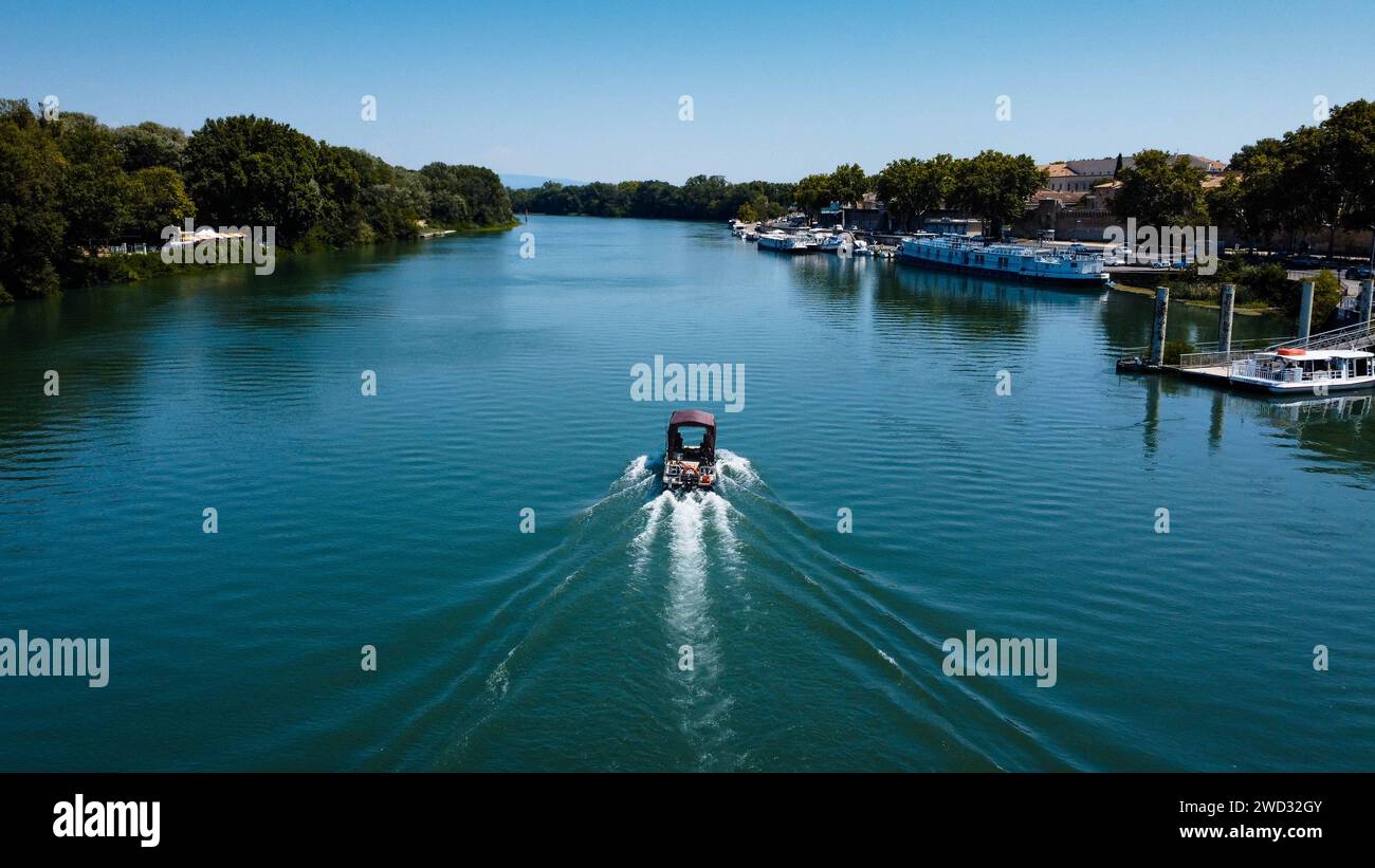 Romantisches Bild mit dem Boot auf der Rhone durch die Stadt Avignon. Boot mit Wasserweg, fotografiert von einer Drohne. Provence Tourist und h Stockfoto