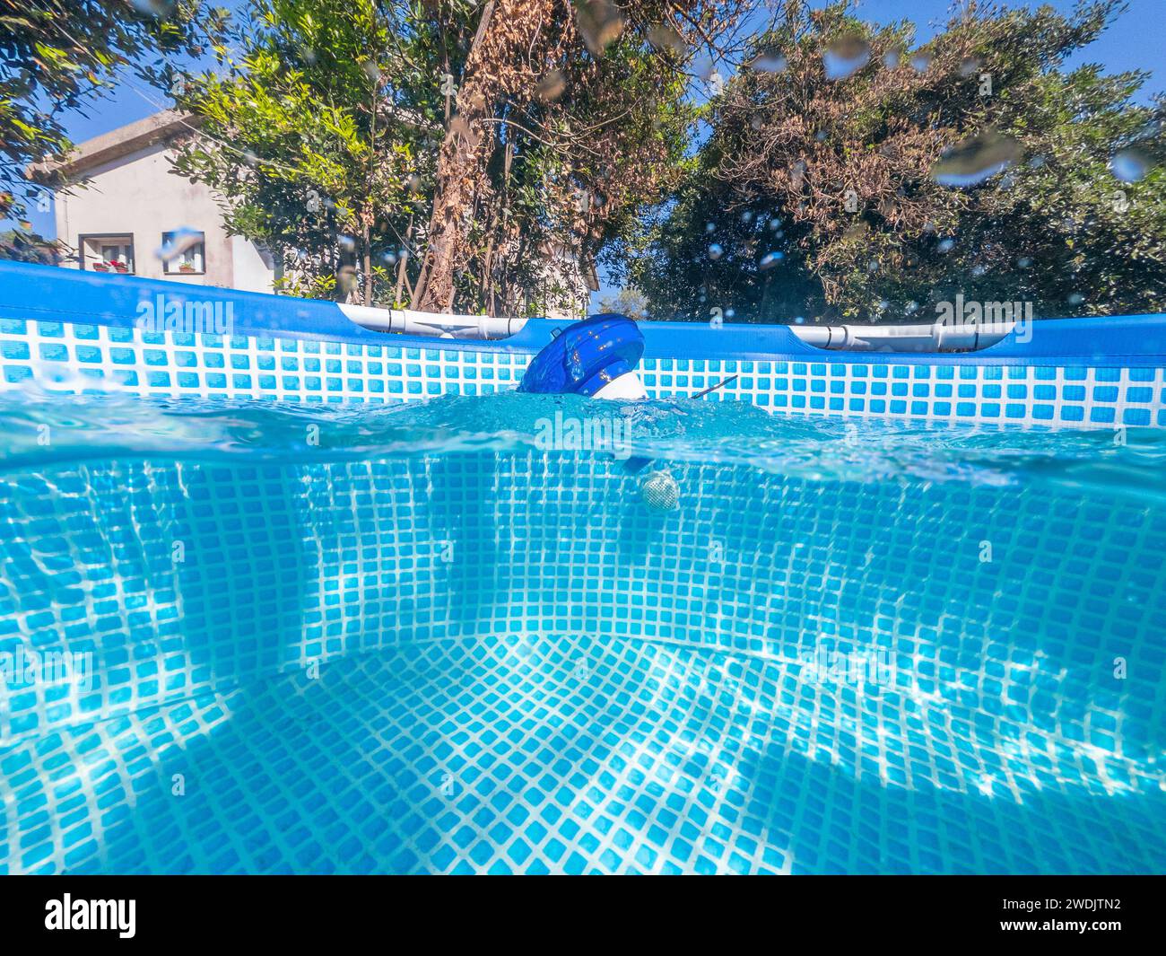 Geteilter Unterwasserblick auf einen Chlorfloater Spender in einem Pool eines Privathauses Stockfoto