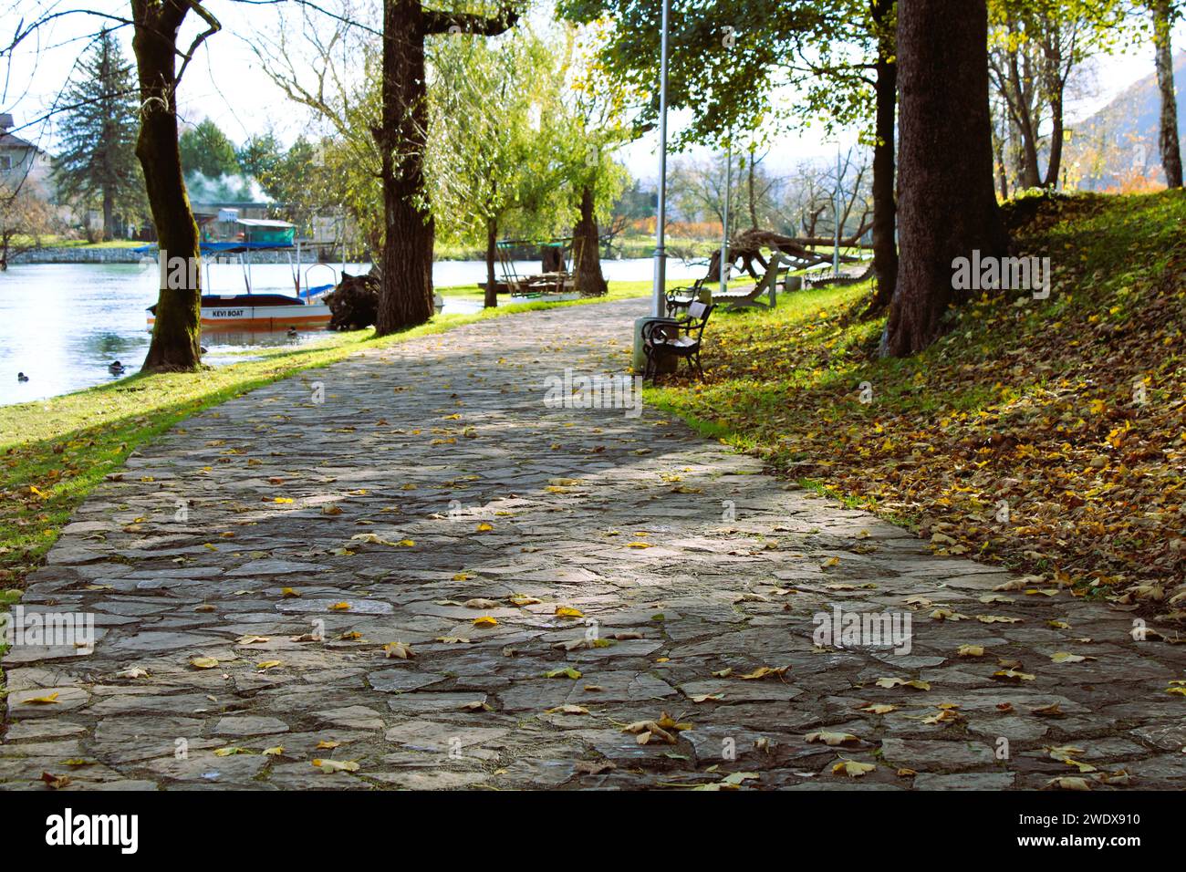 Ein Spaziergang durch den Park an einem sonnigen Herbsttag. Auf der rechten Seite der Bank, auf der linken Seite der Fluss Una, Bihac Bosnien und Herzegowina. Stockfoto