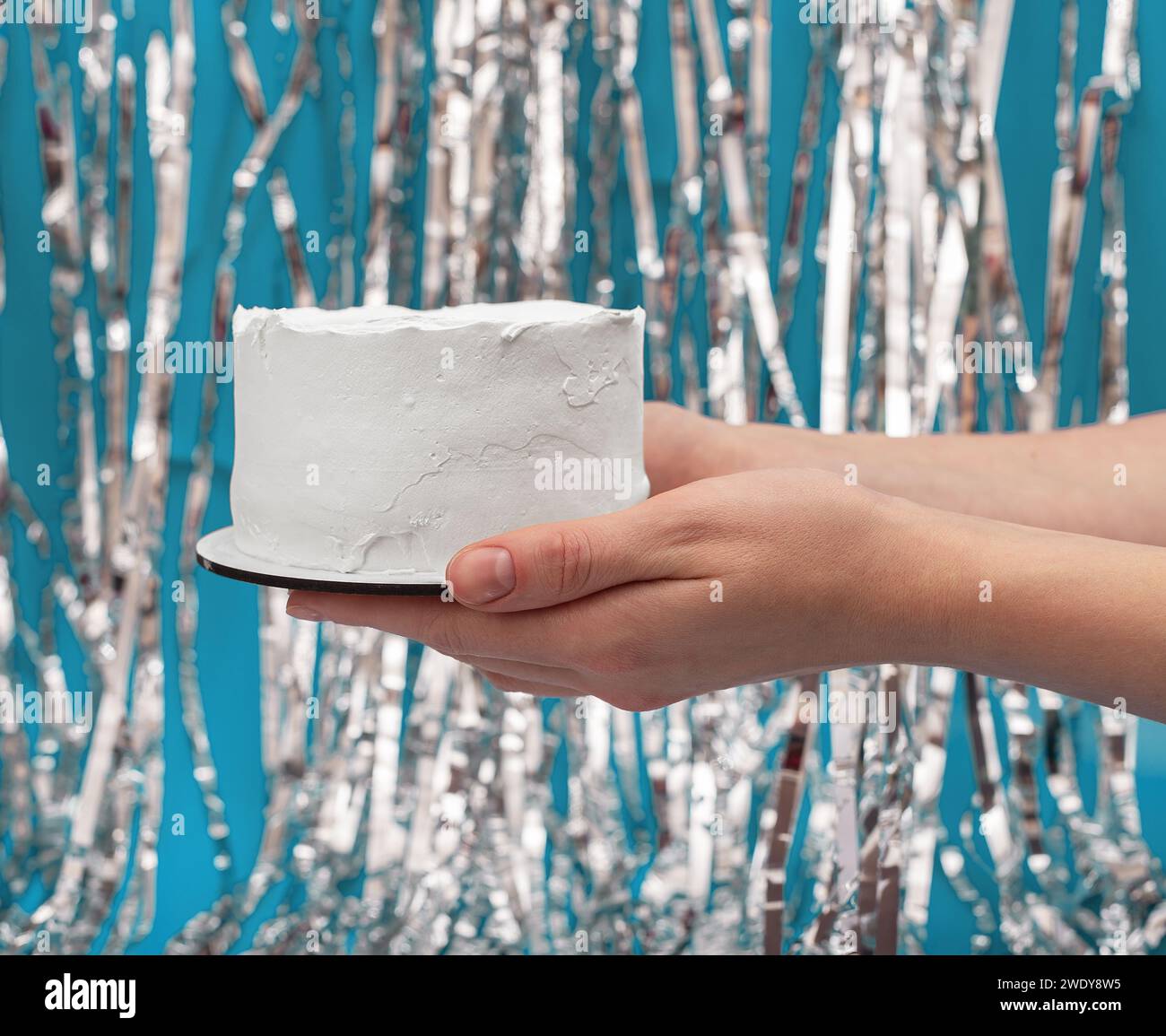 Hände halten einfache weiße Geburtstagskuchen-Mockup Stockfoto