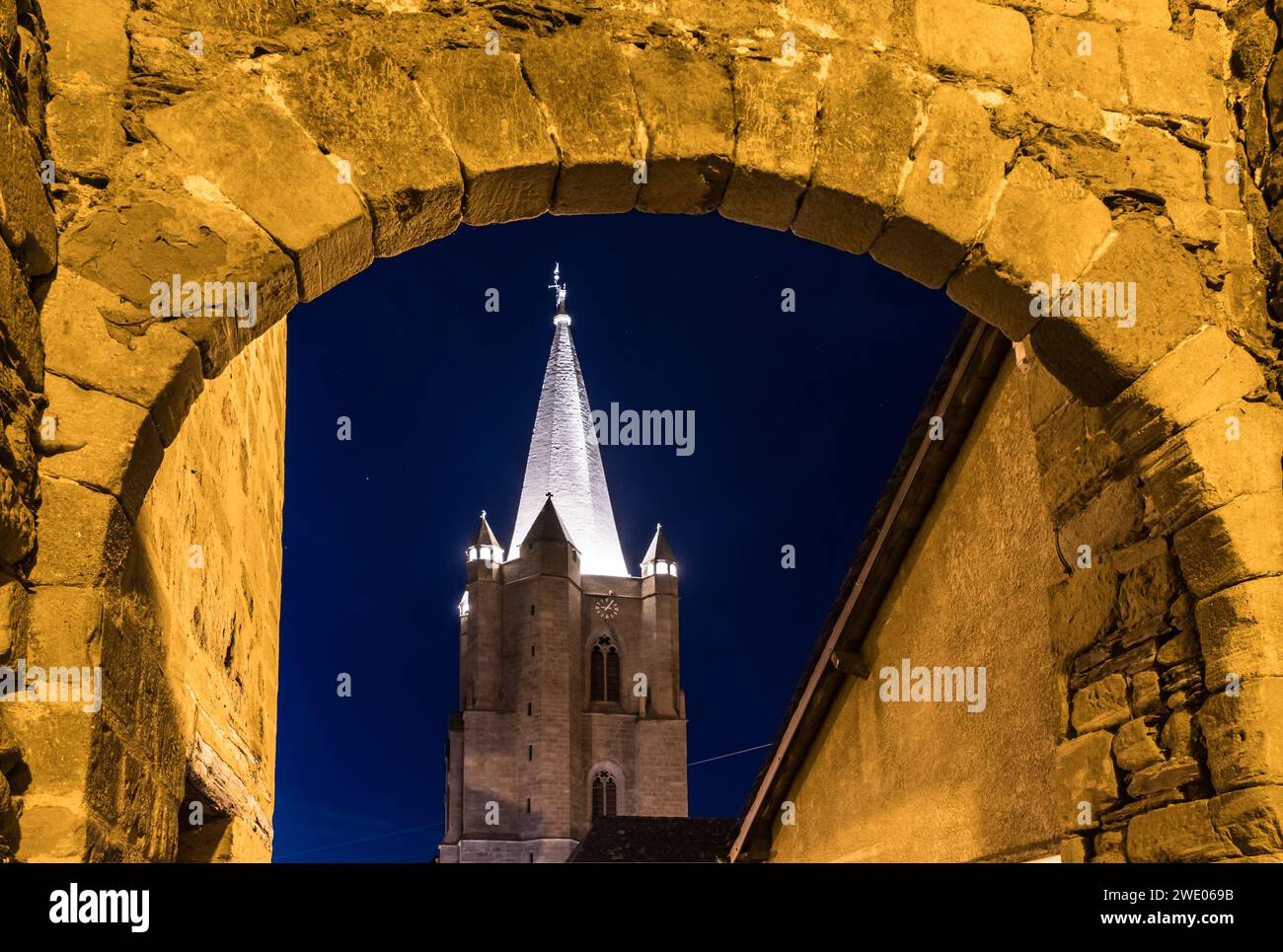 Vue nocturne du clocher de l'église Saint Martin vu à travers la porte d'entrée de la cité médiévale Stockfoto