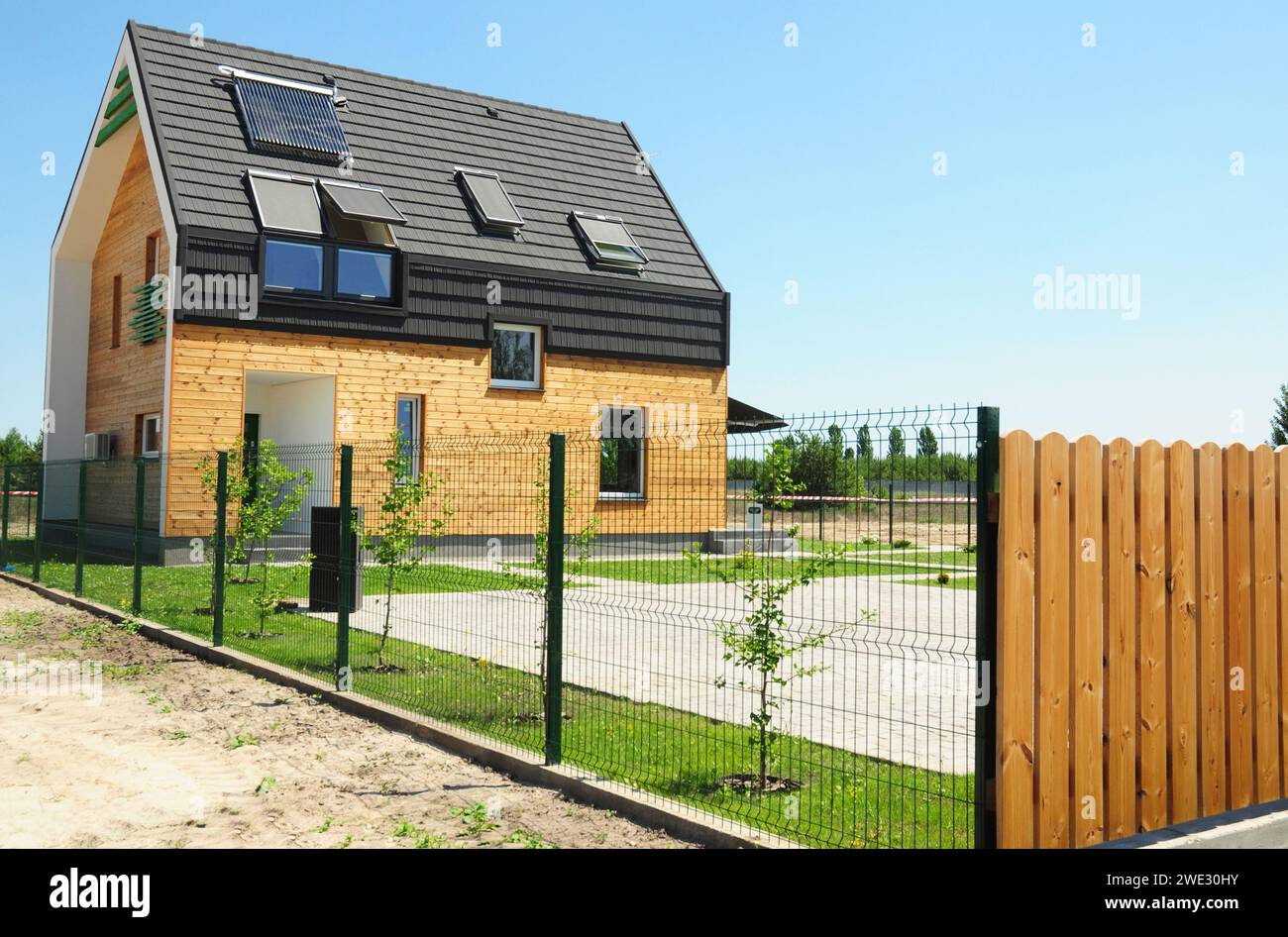 Passivhaus-Konzept. Modernes Haus mit Isolierung, Holzwände, Dachfenster, Solarpaneele, Solaranlage auf dem Dach für Energie-sav Stockfoto