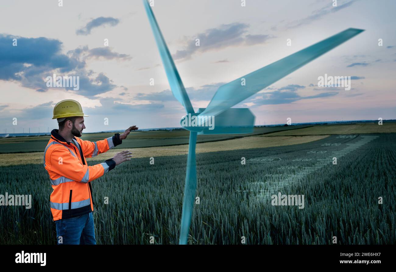 Wartungstechniker, der in der Nähe einer digitalen Windkraftanlage vor Ort arbeitet Stockfoto