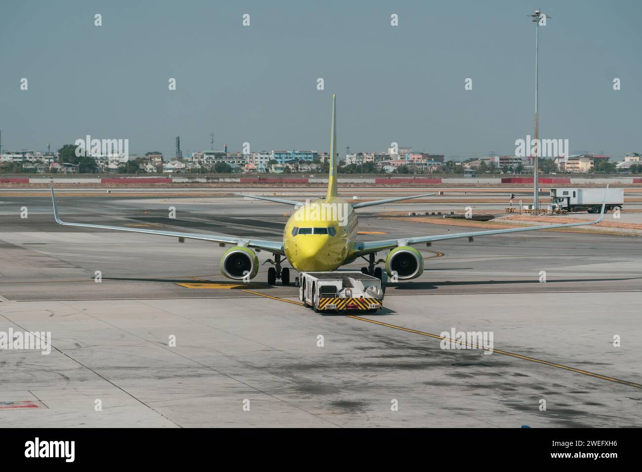 Das Flugzeug schiebt den Schlepper vor dem Starten der Motoren und dem Rollen, Vorderansicht Stockfoto