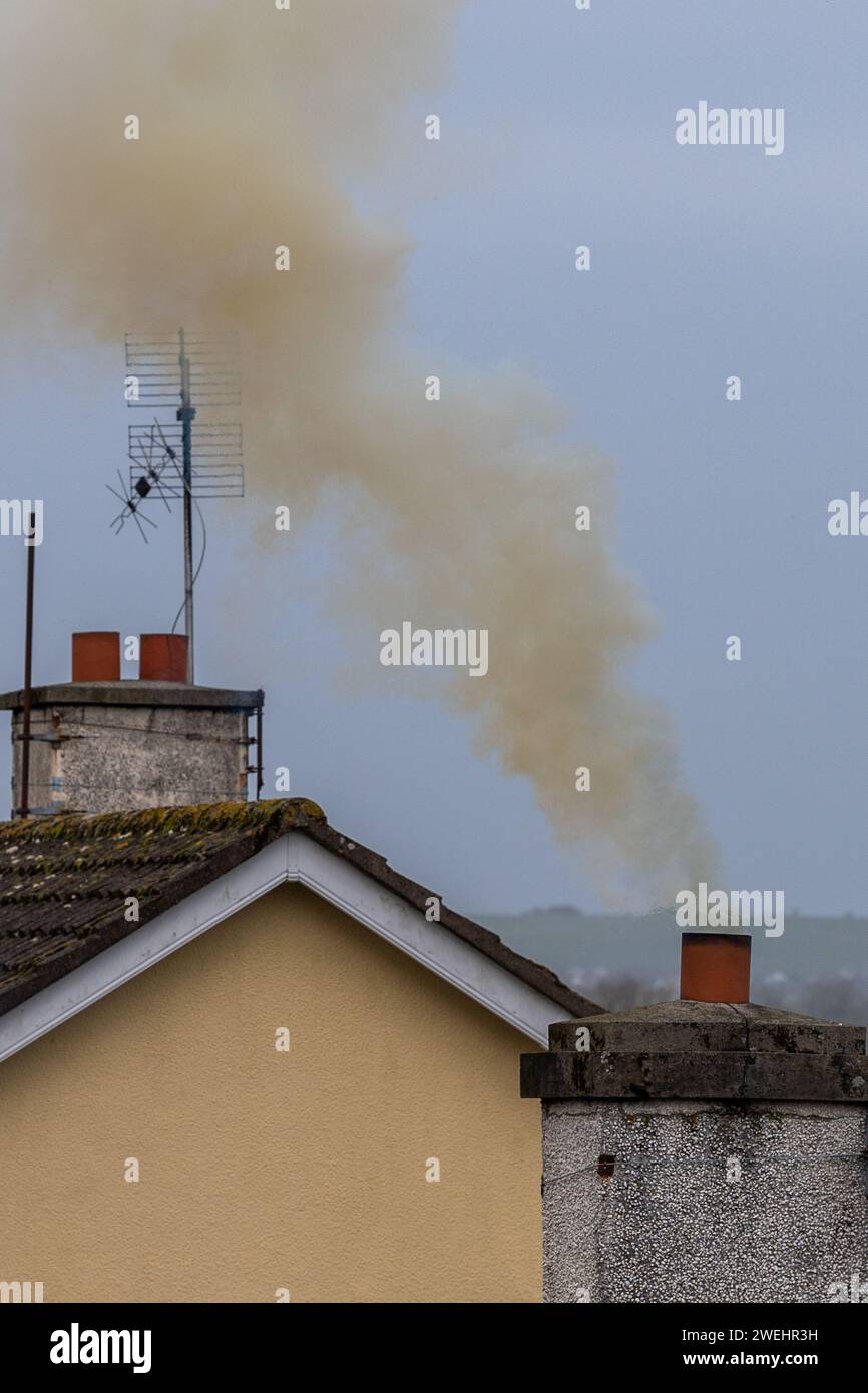 Rauch steigt aus einem Hausschornstein in Irland auf Stockfoto