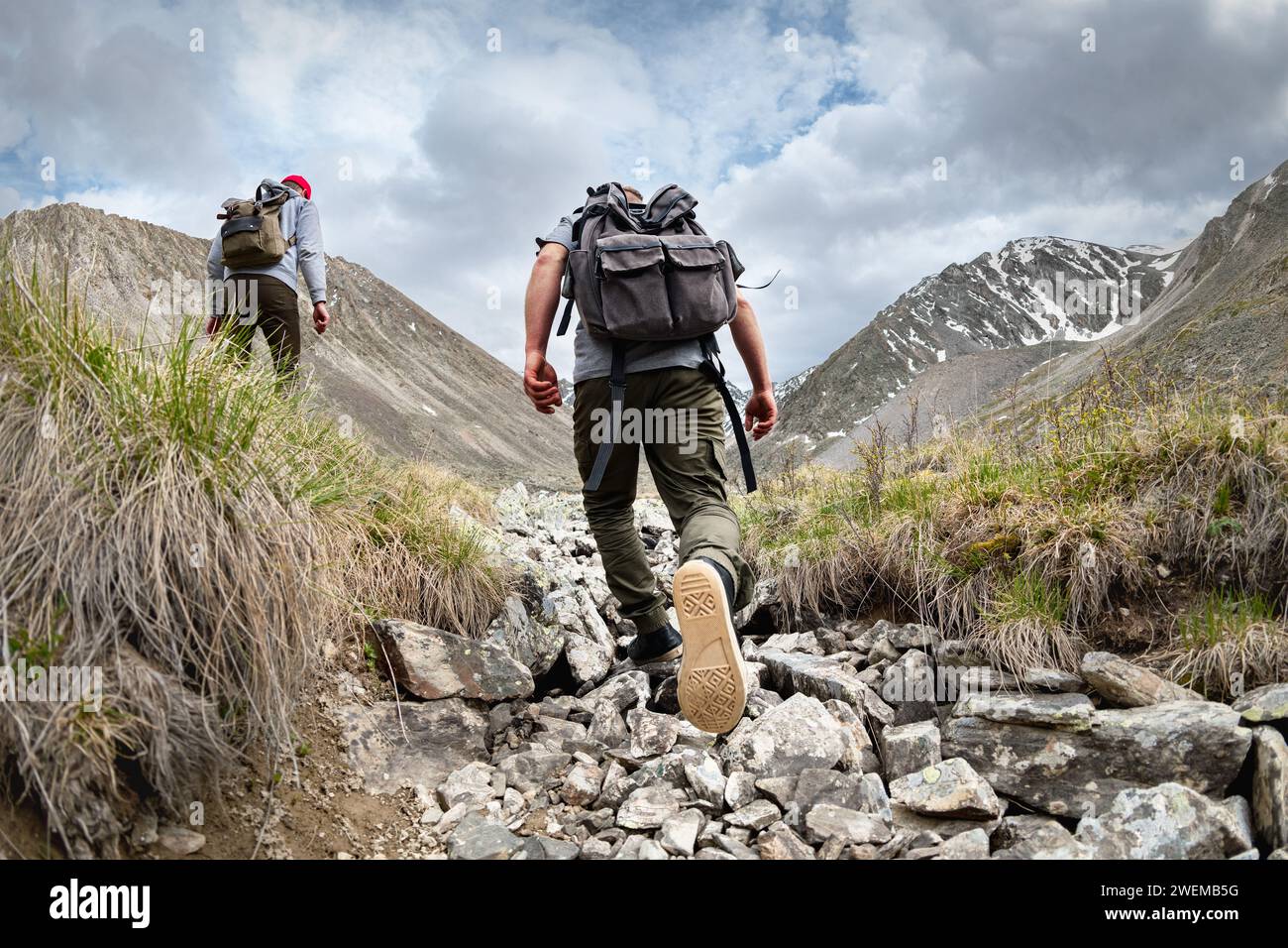 Zwei aktive junge Touristen Wanderer mit Rucksäcken spazieren in den Bergen Stockfoto