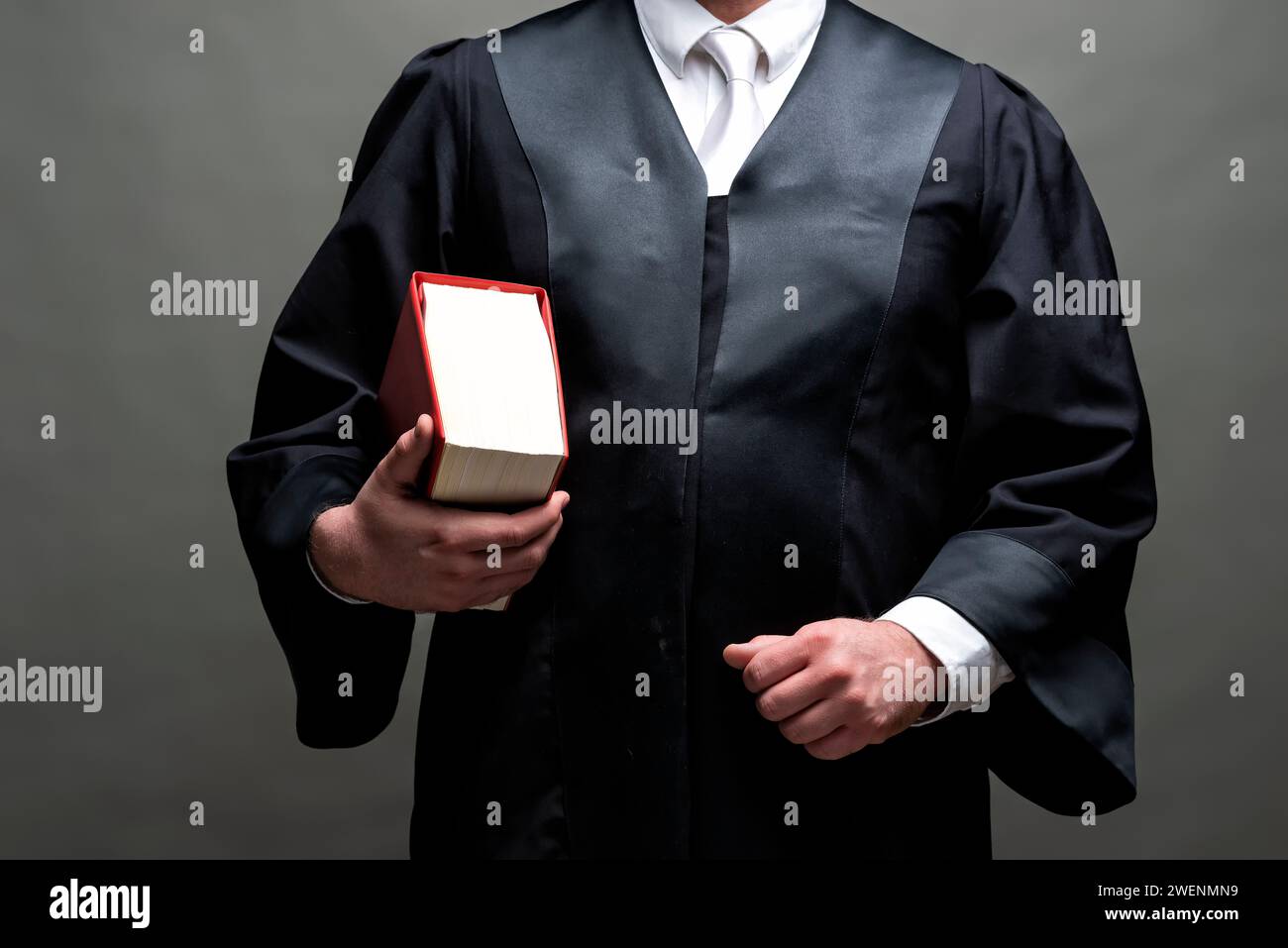 deutscher Anwalt mit klassischem schwarzem Gewand, weißer Krawatte und Buch Stockfoto