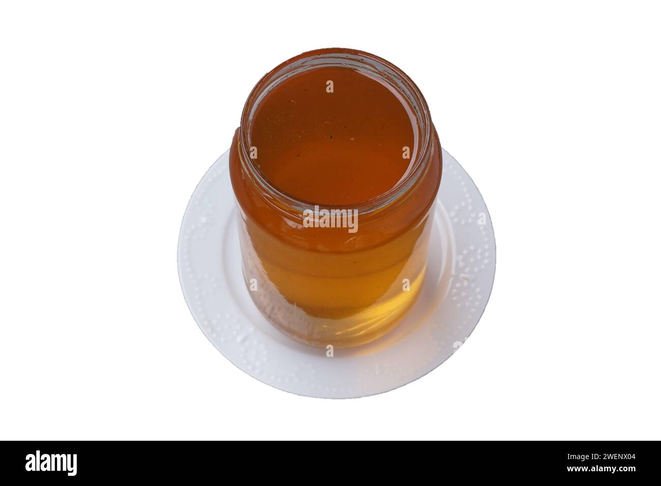 Blütenhonig in einem Glas, isoliert auf weißem Hintergrund Stockfoto