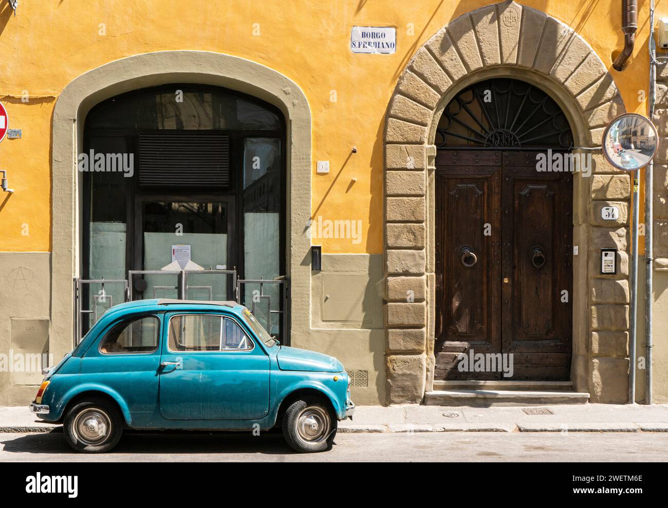 Blue Fiat 500 vor einer gelben Fassade, Oltrarno Viertel, Florenz, Toskana, Italien Stockfoto