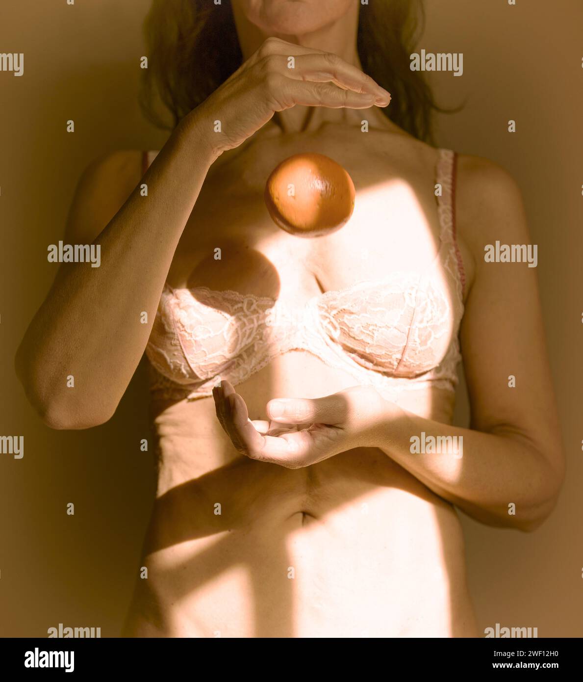 Frau spielt mit Orange in den Händen, frankreich Stockfoto