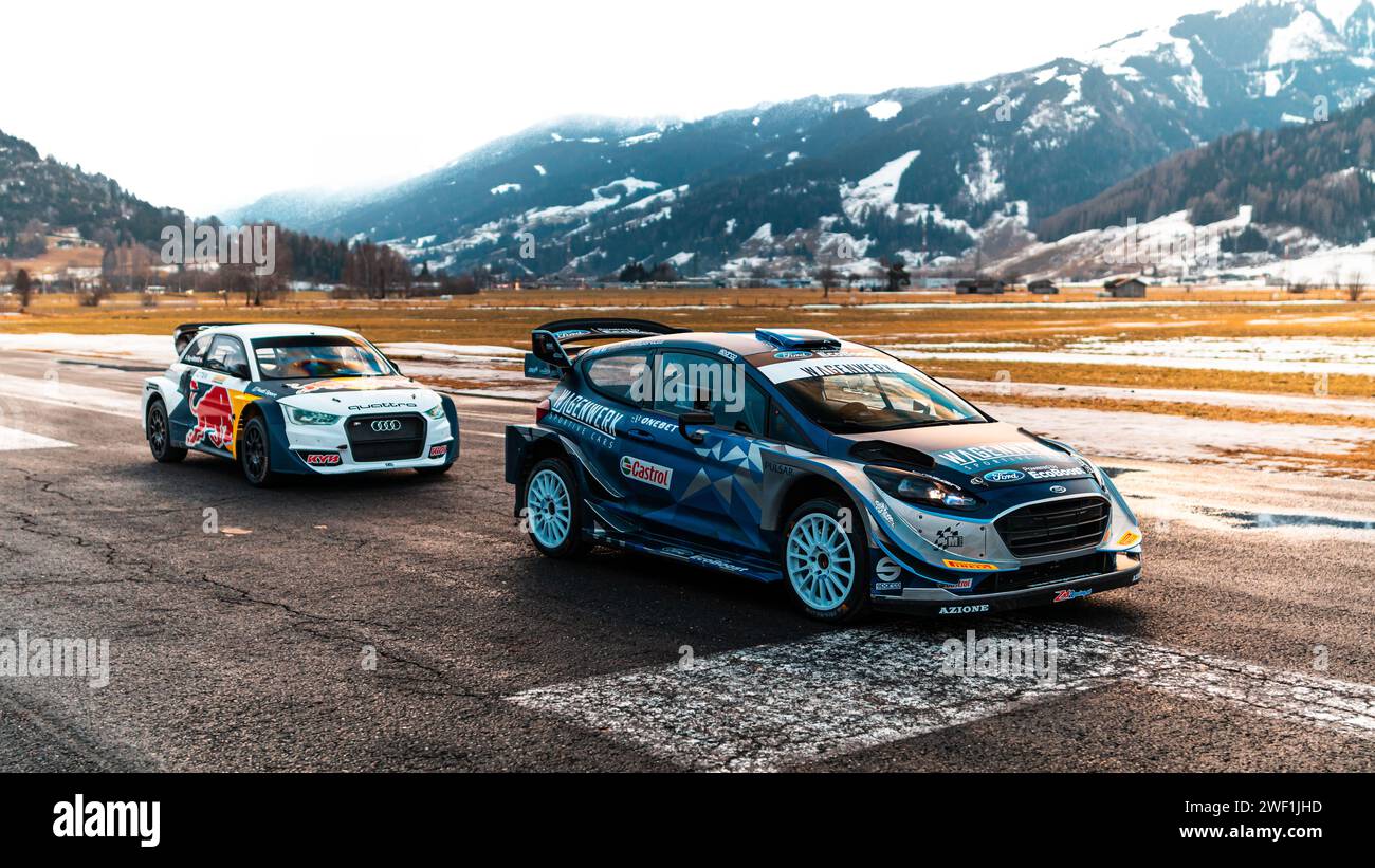 Schöne wrc-Autos auf einem geschlossenen Flughafen testen ihre Fähigkeiten unter den verschneiten österreichischen Alpen. Stockfoto