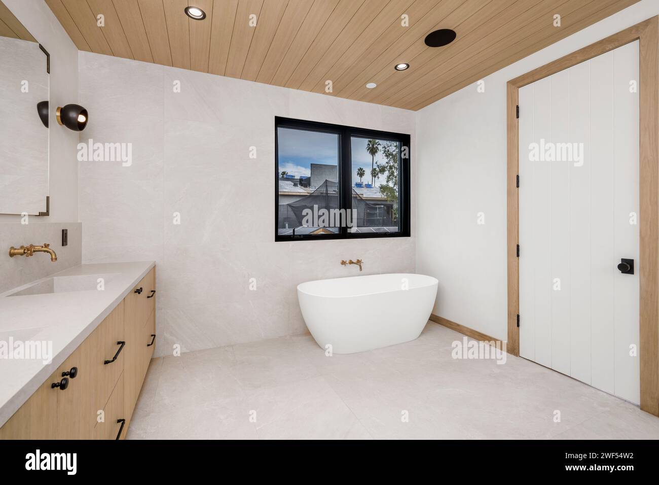 Leeres Badezimmer mit großem Waschbecken und Blick auf das Wasser durch das Fenster Stockfoto