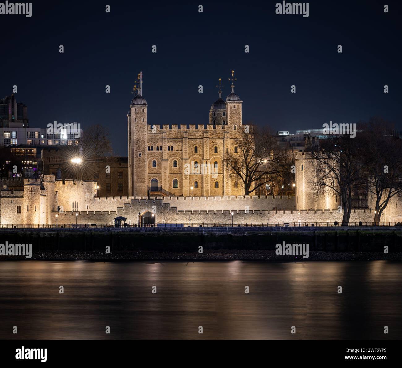 Der Tower of London bei Nacht mit Lichtreflexen auf der Themse. Nachtaufnahmen mit langer Belichtung. Stockfoto