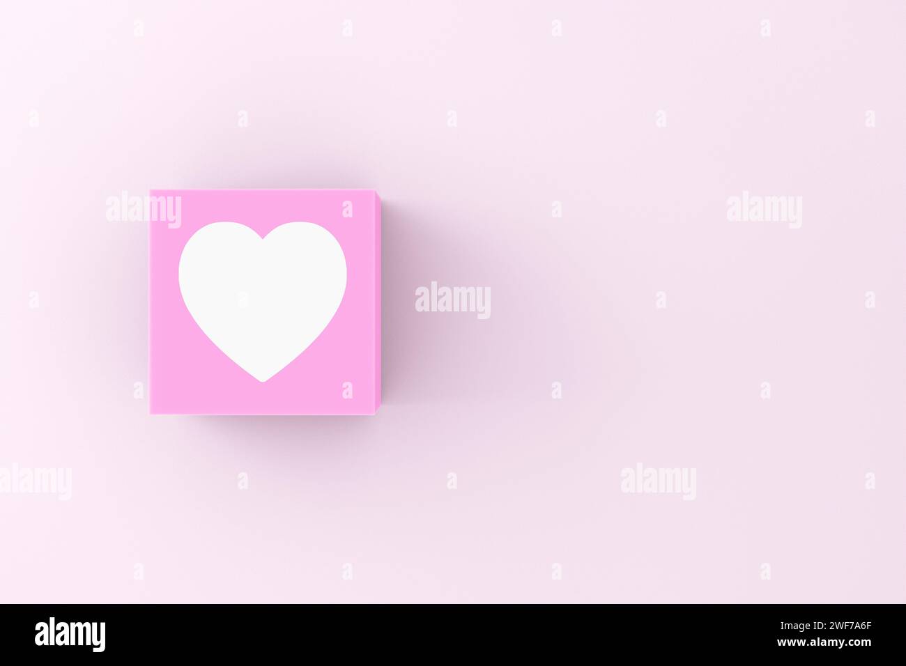 Herzsymbol auf einem rosafarbenen Würfel-Block. Liebe, Beziehung und valentinstag-Konzept. Stockfoto