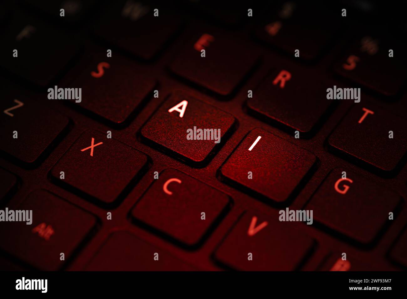 Die Tastatur wird mit rotem Licht beleuchtet, das die Buchstaben A i markiert, Nahaufnahme der Buchstaben Stockfoto