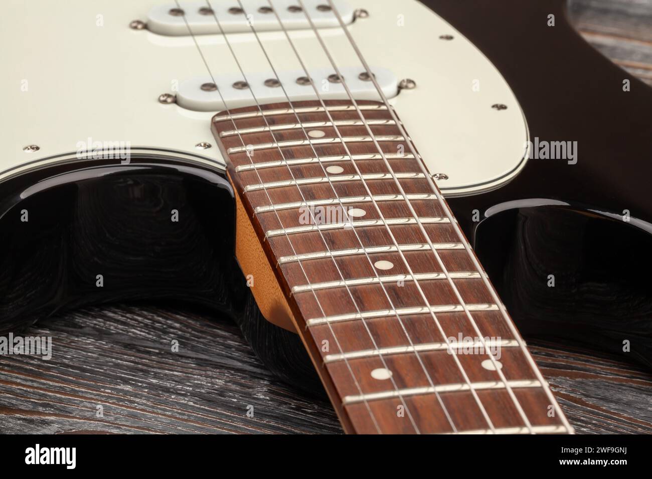 E-Gitarren-Griffbrettkörper auf Holzhintergrund Stockfoto