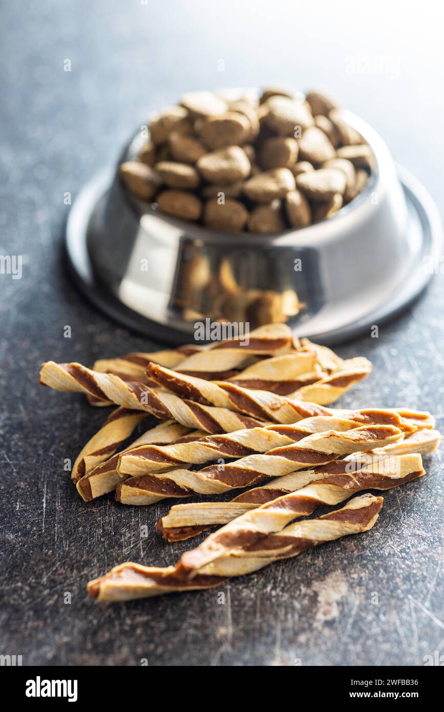 Hundefutter. Snackstangen für Hunde auf dem dunklen Tisch. Stockfoto