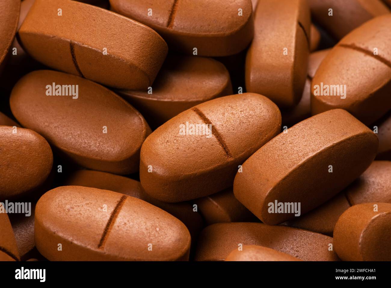 Stapel brauner Tabletten. Verschreibungspflichtige Medikamente. Pharmazeutische Industrie. Die Herstellung von Tablettenpillen. Gesundheitswesen und Medizin. Apotheke. Pharmakologie Stockfoto