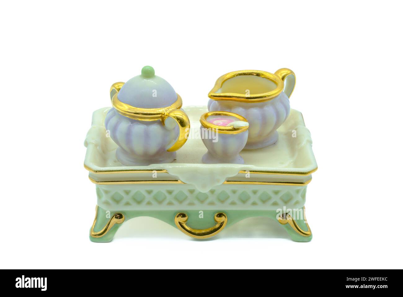Antikes Mini-Tee-Set aus Bone china mit winzigem Teekanne Milch und Zuckerschale auf einem Serviertablett, das ebenfalls aus Bone china oder Porzellan hergestellt wird Stockfoto