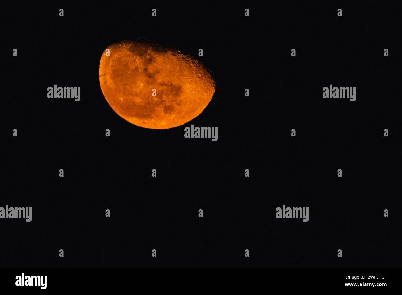 Mond, Gibbous Phase. Heute und heute Abend wird die Mondphase nachlassen. Dies ist die erste Phase nach dem Vollmond und dauert etwa 7 Tage. Der Mond hat eine kupferfarbene Farbe das Phänomen wird durch Rayleigh-Streuung des Sonnenlichts durch die Erdatmosphäre verursacht und seine Wahrnehmung wird durch die atmosphärische Brechung verstärkt. Sie tritt beim auf- oder Untergang des Mondes und während seiner Sonnenfinsternisse auf. ABPH7012 Copyright: XAntonioxBalascox Stockfoto