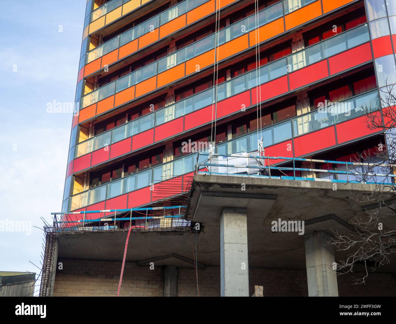 Teil des Baus eines modernen Gebäudes. Fenster und Balkone eines neuen Hochhauses. Unbewohntes unvollendetes Haus. Technologien. Helles c Stockfoto