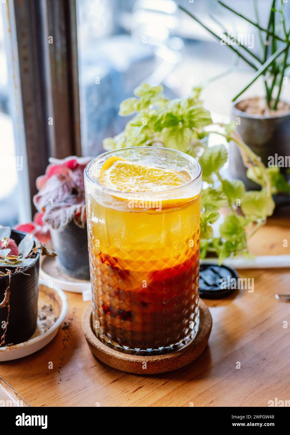 Ein Glas Hummelcocktail mit Eis. Doppelter Espresso mit Orangensaft und Karamellsirup mit Orangensaft und Orangenscheiben auf dem Glas. Frisch und Stockfoto
