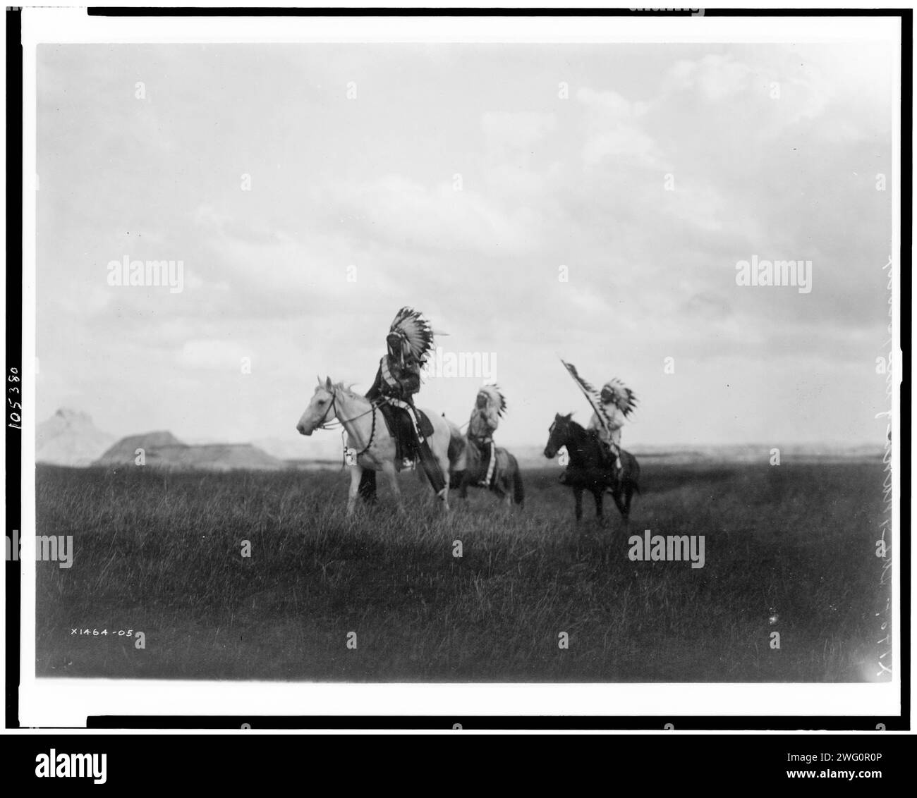 Der marsch der Sioux, 1905. Drei Sioux-Indianer zu Pferd auf Ebenen mit Felsformationen im Hintergrund. Stockfoto