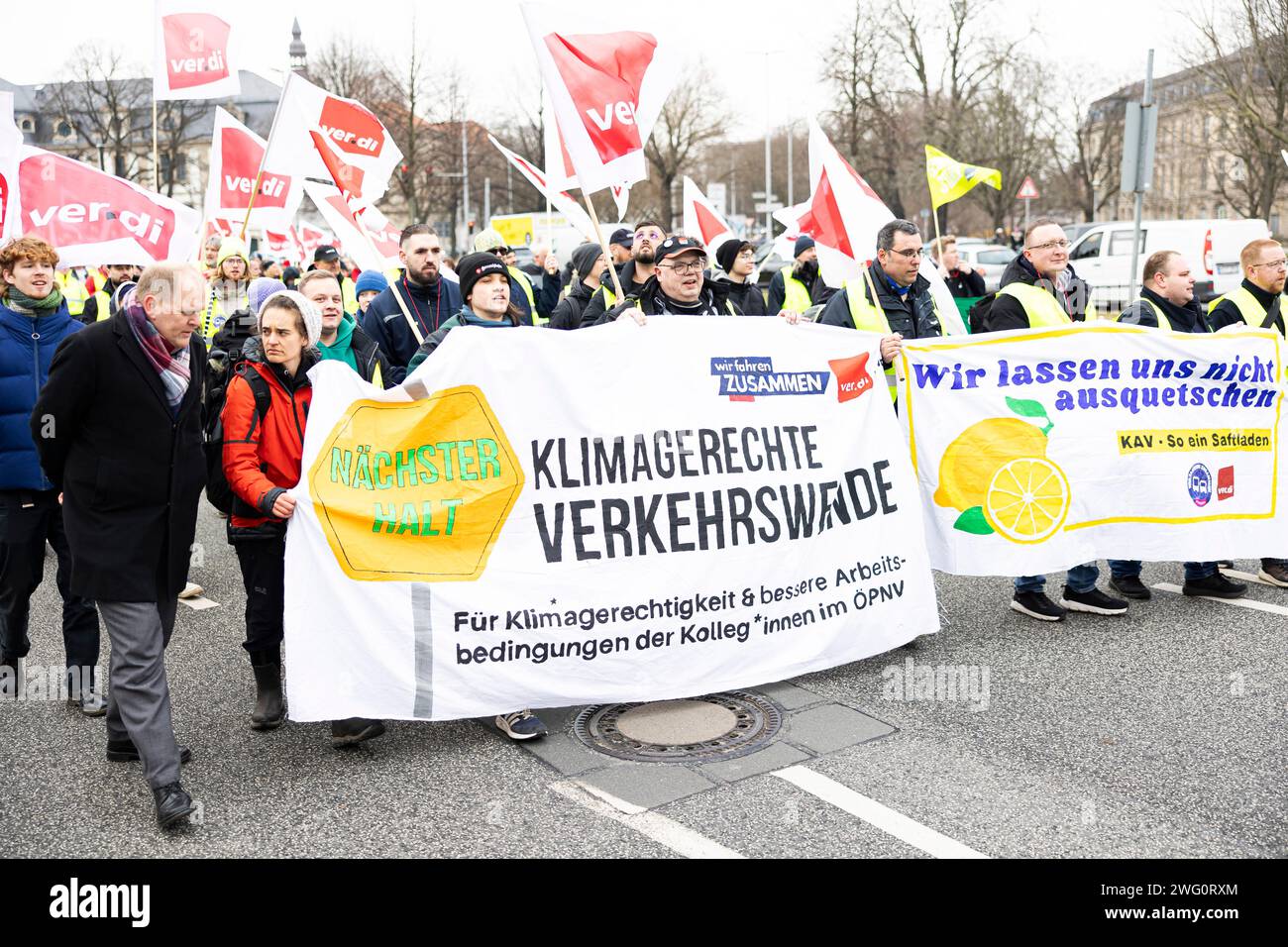 Hannover, Deutschland. Februar 2024. Teilnehmer einer Verdi-Demonstration laufen durch die Innenstadt von Hannover mit Bannern mit der Aufschrift „Next Stop - Climate-friendly Transport Turnaround - for Climate Justice & better Working conditions for People in Public Transport“ (l) und „We will not be Squeeezed Out – KAV – so ein sap Store“ (r). Die gewerkschaft Verdi hatte die Beschäftigten des öffentlichen Verkehrs in mehr als 80 Städten dazu aufgerufen, im bundesweiten Lohnstreit in regionalen Verhandlungen einen Warnstreik zu führen. Quelle: Michael Matthey/dpa/Alamy Live News Stockfoto
