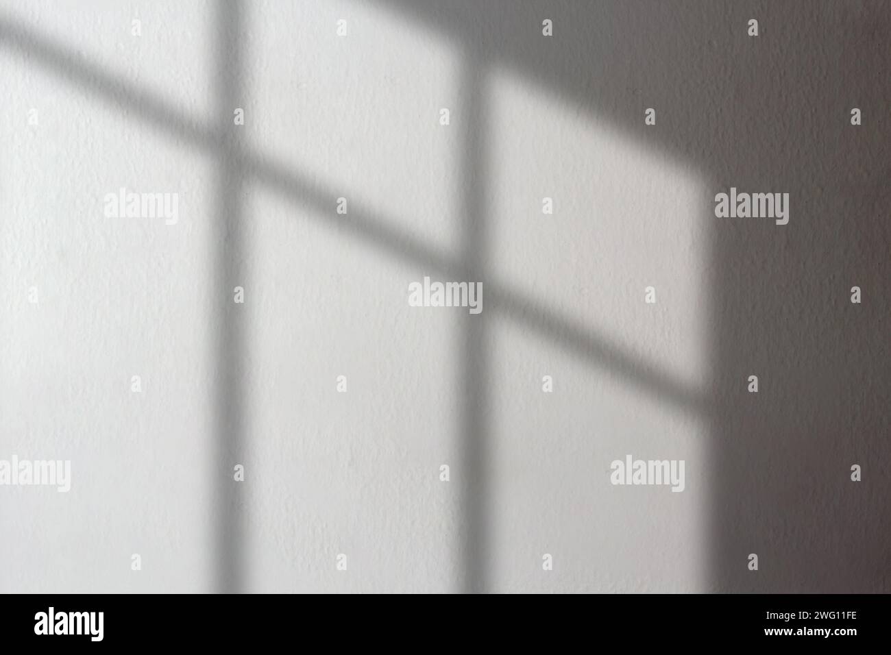 Organischer Fensterschatten auf weißer Betonwand. Überlagerungseffekt für Foto. Szene mit natürlichem Licht. Schattenüberlagerungseffekt. Stockfoto