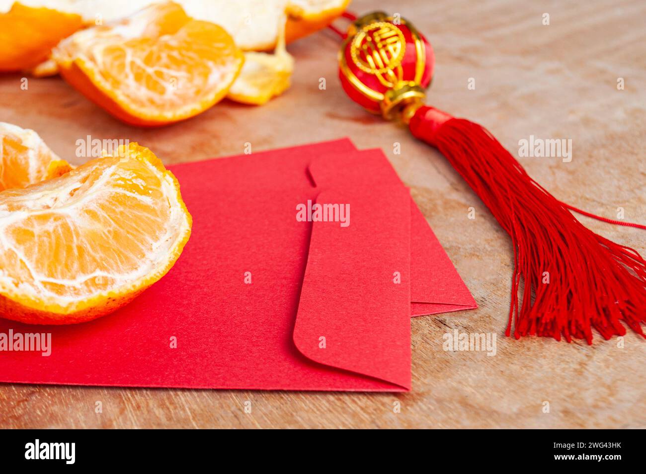 Peal Mandarine Orangen und chinesischer Umschlag für das neue Jahr. Chinesisches Neujahrsfest. Stockfoto