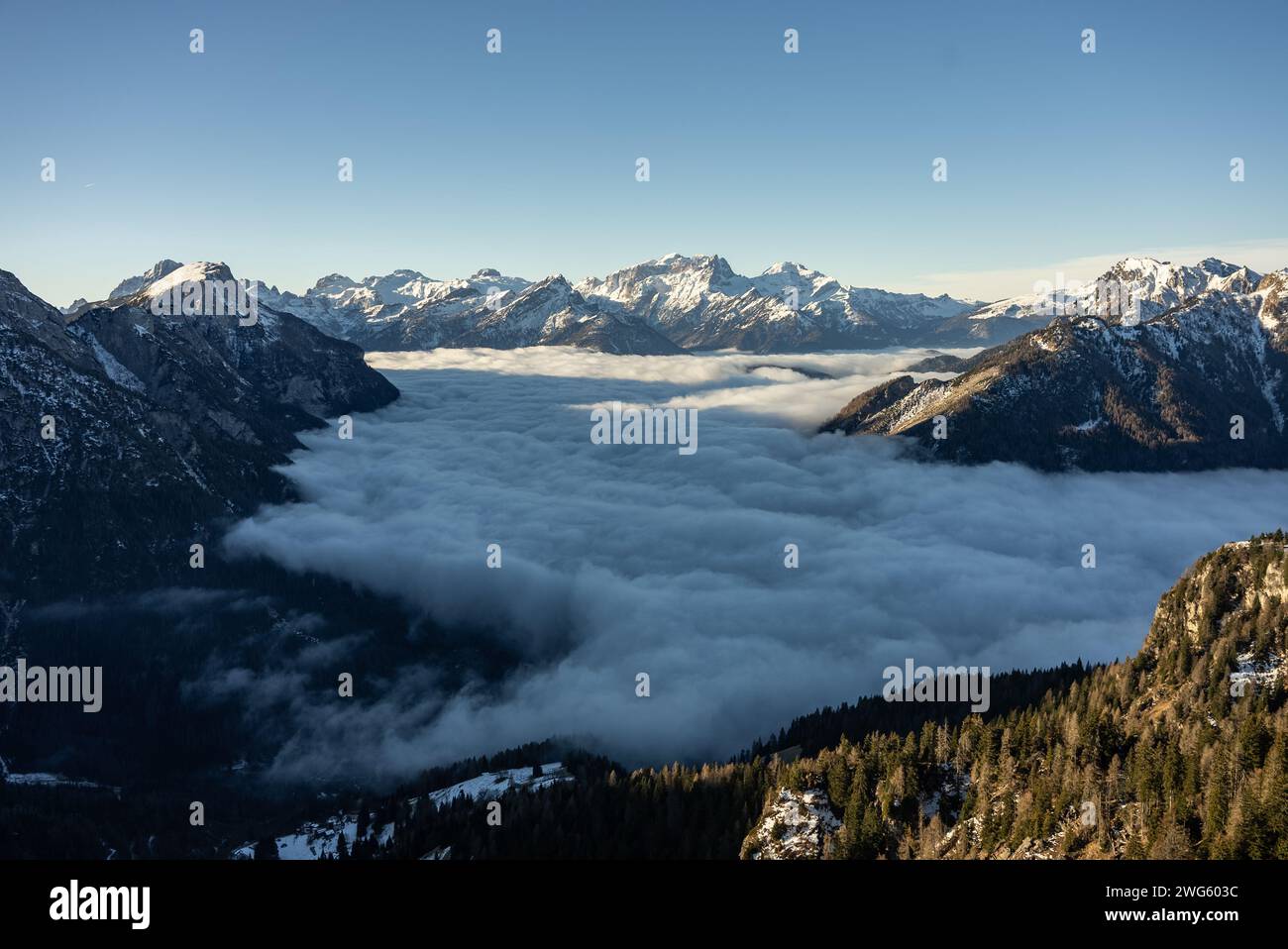 Mountain above clouds. Civetta resort. Panoramic view of the Dolomites mountains in winter, Italy. Ski resort in Dolomites, Italy. Aerial  drone view Stockfoto