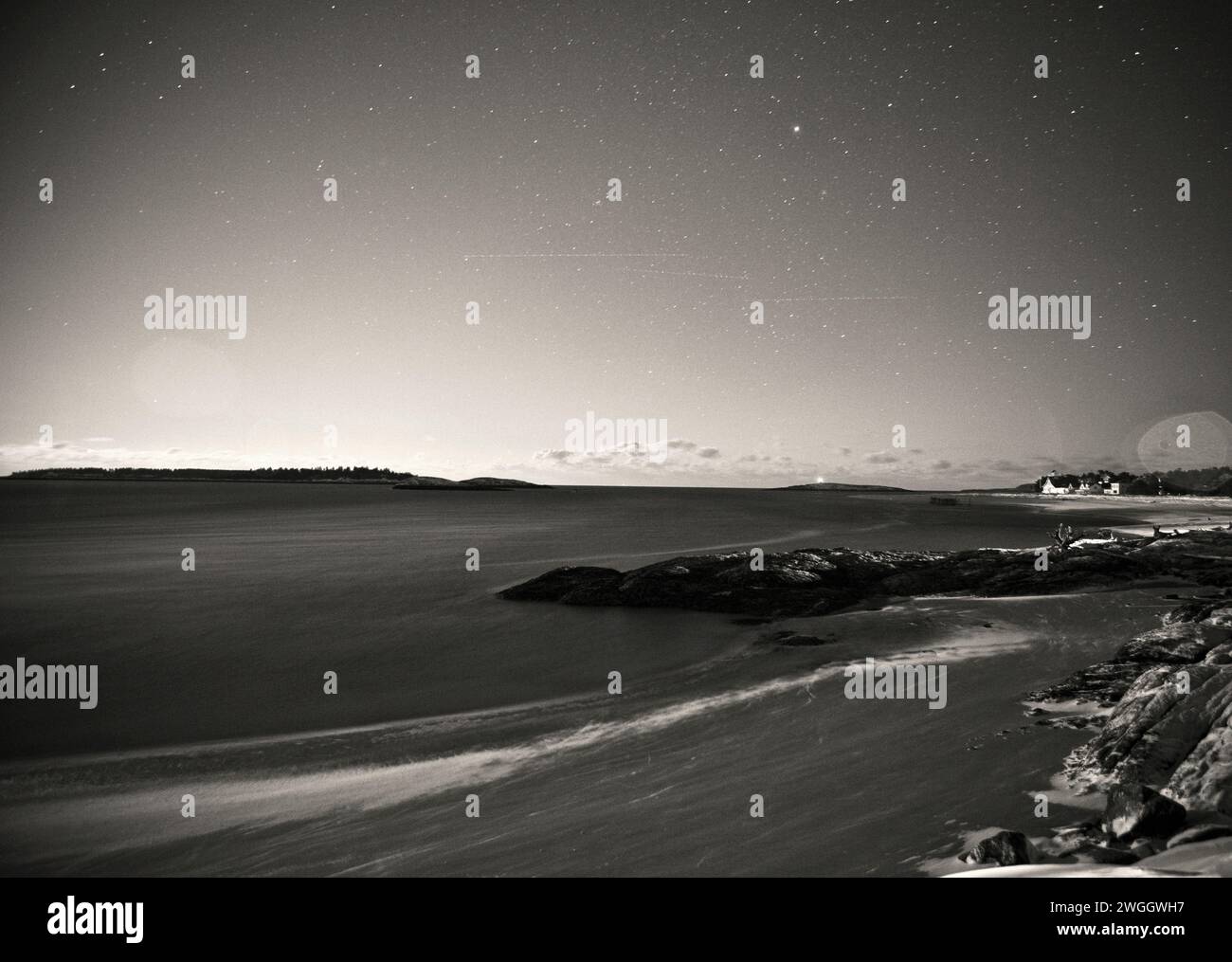 Die zerklüftete Küste von Maine, einschließlich des Seguin Island Lighthouse, ist auf diesem Nachtfoto aus dem Popham Beach State Park zu sehen. Stockfoto