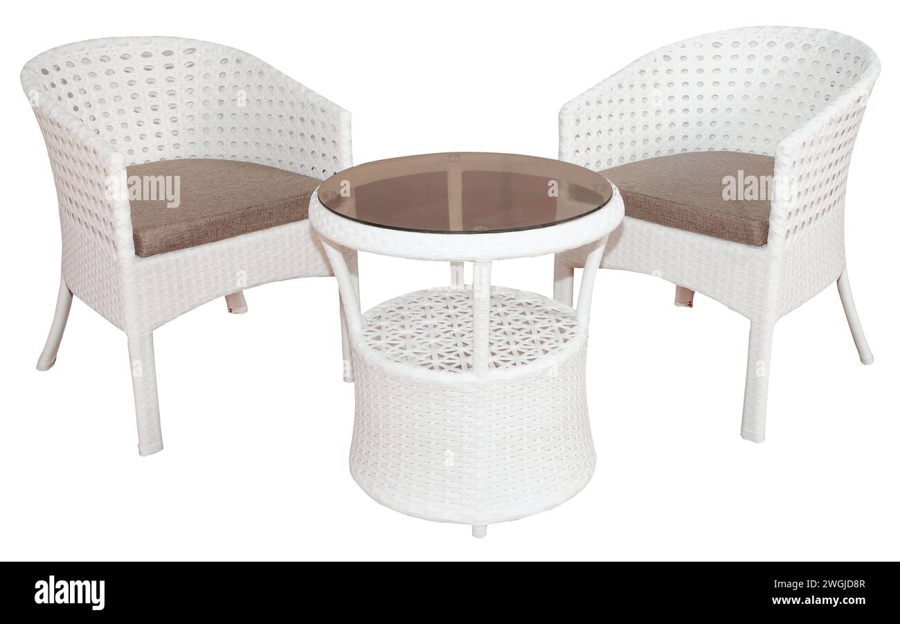 Weißes Rattan-Korbmöbel bestehend aus zwei Stühlen und einem Tisch mit Glasplatte. Stilvolle Outdoor- oder Gartenmöbel. Stockfoto