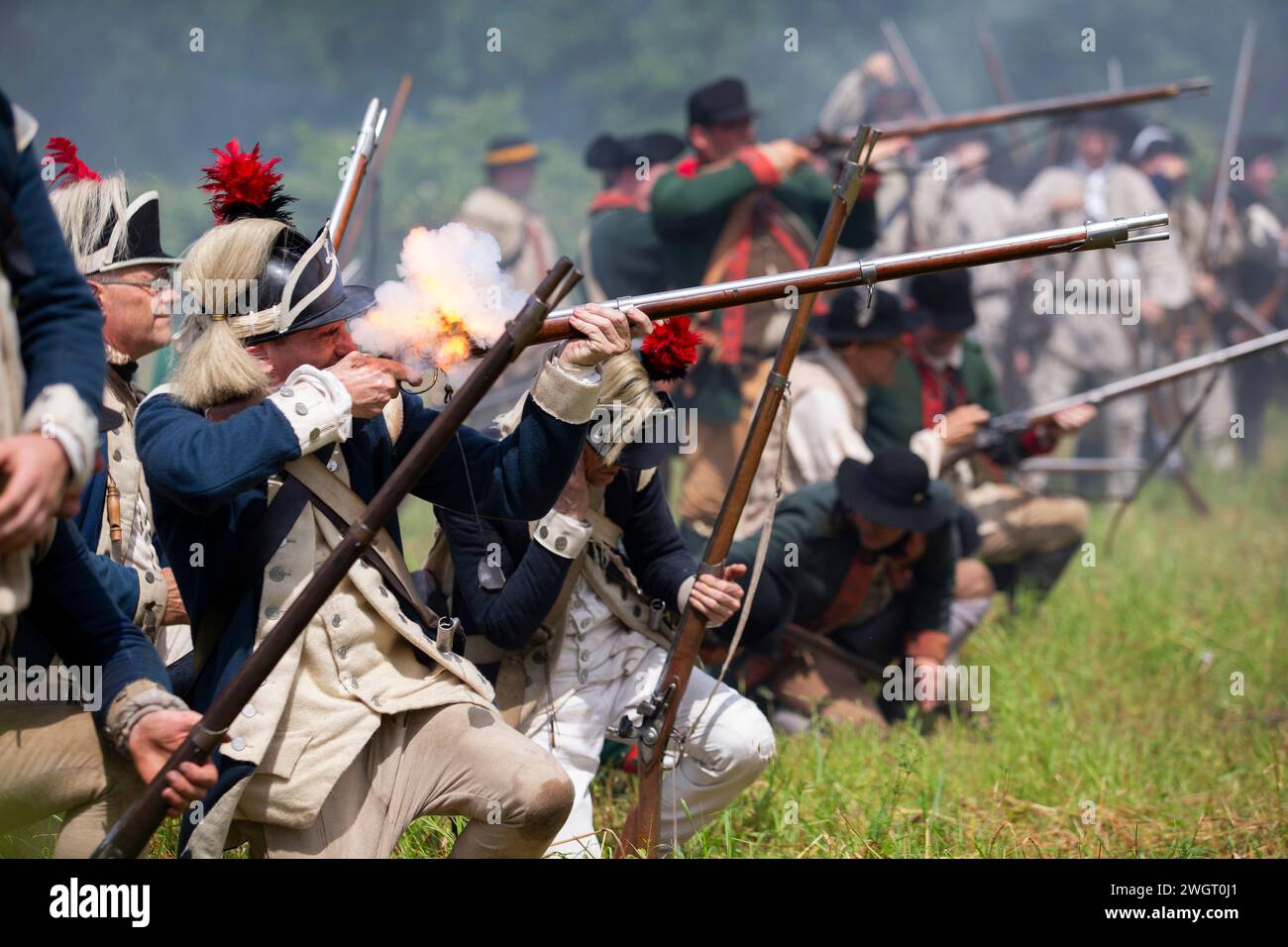 Historische Reenactors führen im Old Sturbridge Village in Sturbridge, M, eine revolutionäre Schlacht zwischen den britischen Roten Mänteln und amerikanischen Rebellen aus Stockfoto