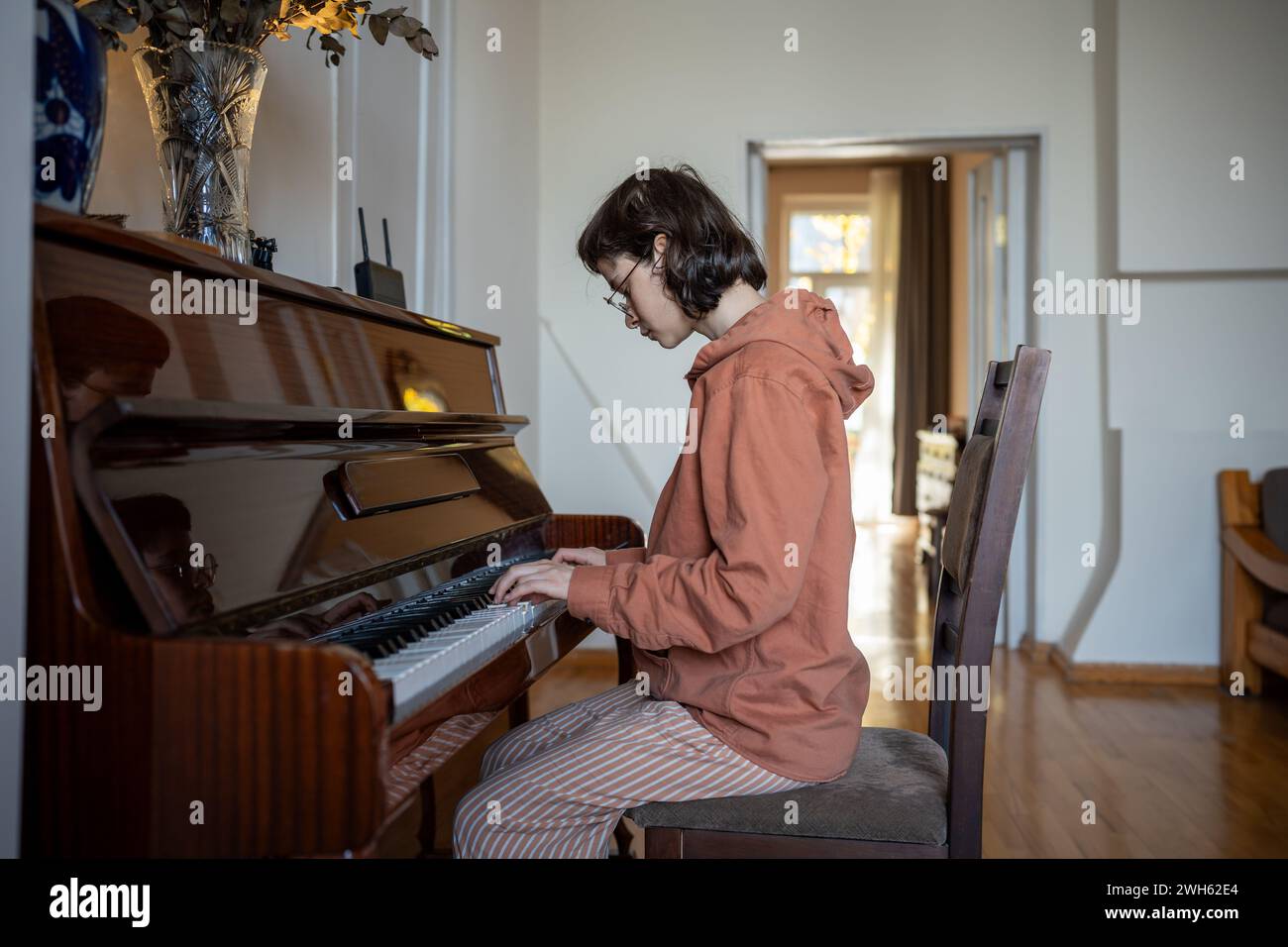 Pianistin, die Klaviertasten berührt, klassische Musik spielt, Fähigkeiten zu Hause übt Stockfoto