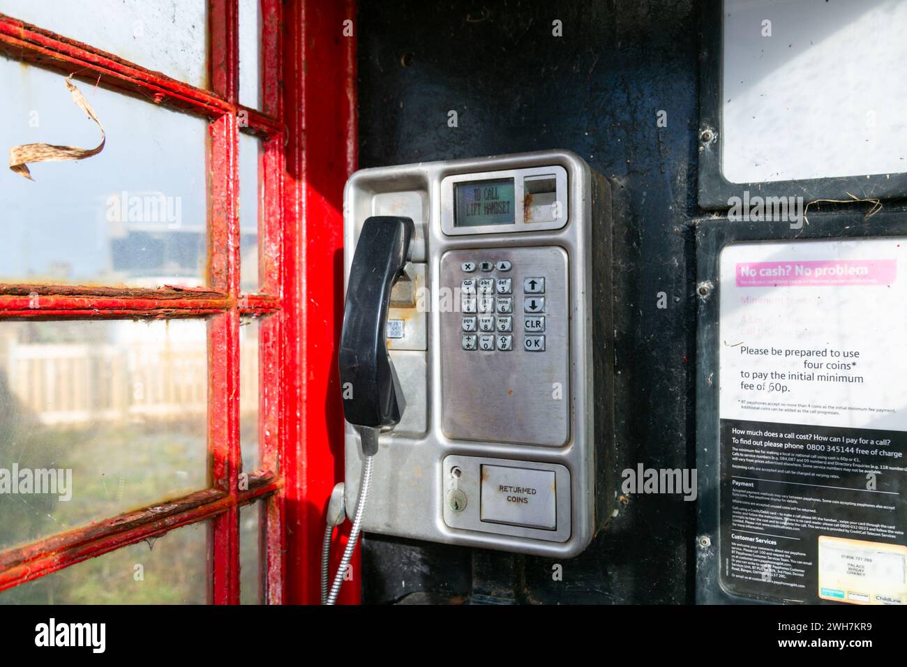 Alte öffentliche Telefonbox oder Kiosk mit Drucktaste und Mobilteil, Großbritannien Stockfoto