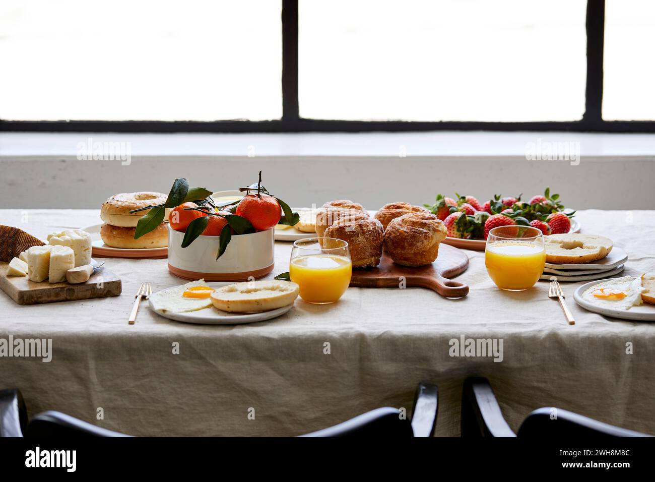 Frühstückstisch mit Gebäck, Orangensaft und Obst Stockfoto