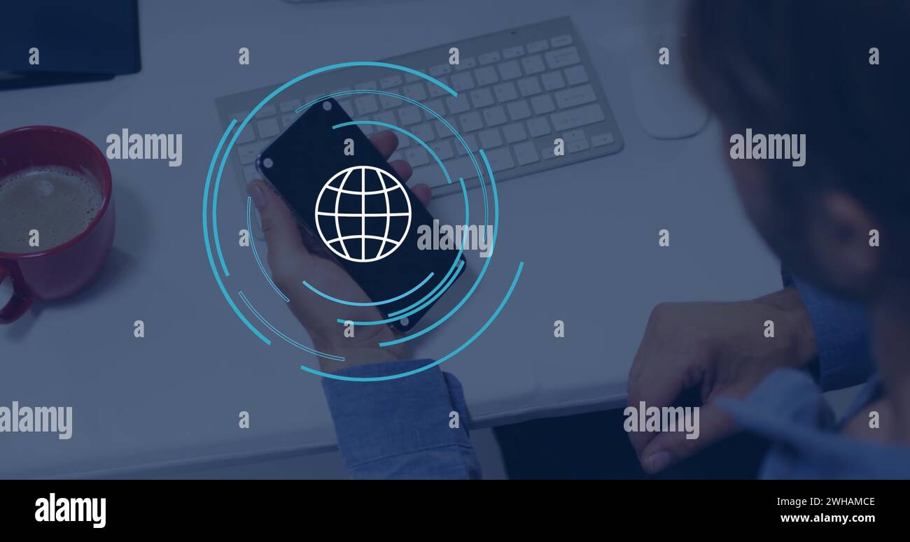 Bild eines Globus-Symbols über einem kaukasischen Geschäftsmann, der im Büro ein Smartphone verwendet Stockfoto