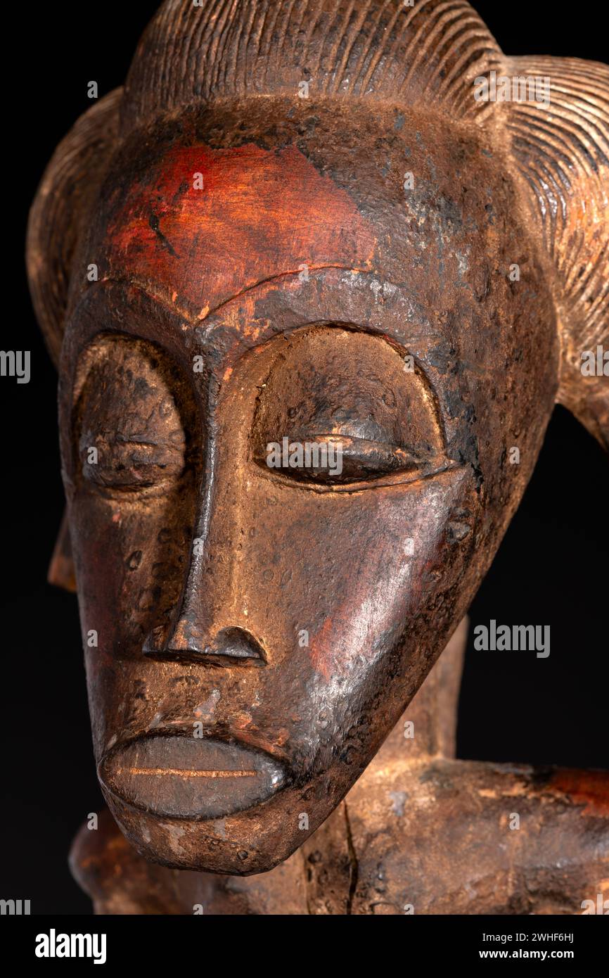 Nahaufnahme einer hölzernen Senufo männlichen Figur aus der Elfenbeinküste. Afrikanische Kunst mit meisterhafter Handwerkskunst und spirituellem Symbolismus. Stockfoto